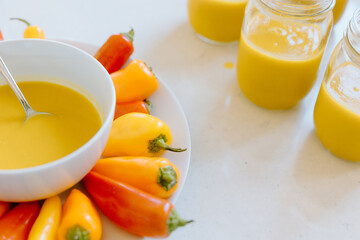 Preparing butternut squash soup with colorful peppers