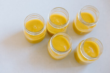 Chef preparing butternut squash soup in glass jars