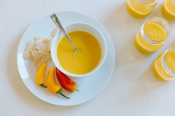 Preparing butternut squash soup with tortilla chips