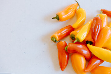 Colorful sweet mini peppers resting on white countertop