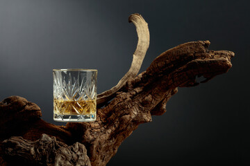 Glass of whiskey on a old snag.