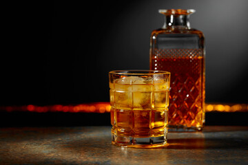 Whiskey with ice on a dark background.