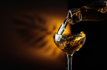 Rum being poured from a bottle into a glass.