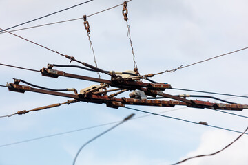 A power line with a lot of wires hanging from it