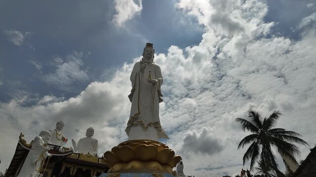 Lien Hoa Pagoda, My Tho, Tien Giang, Vietnam: Timelapse Video of Clouds Moving Behind Avalokiteshvara Guanyin Buddha Statue in Serene Temple Garden