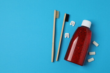 mouthwash, toothbrush, dental care tools on blue background
