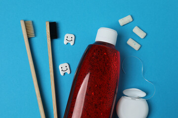 mouthwash, toothbrush, dental care tools on blue background
