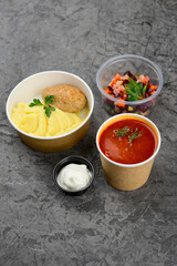lunch borscht mashed potatoes with a cutlet and salad in a disposable container