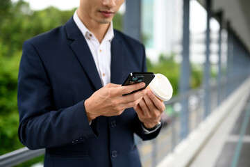 Adult businessman checking smartphone messages during morning commute