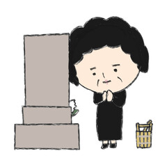 お墓の前で合掌するおばちゃん