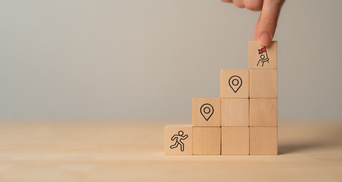 Career Path and Development Strategy Concept. Arranging wooden blocks with icons success roadmap and journey, symbolizing a structured career path and strategic development. Planning, growth, progress