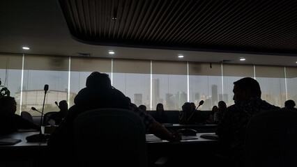a group of people are having a meeting in a room