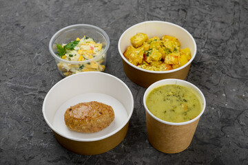 lunch pea cream soup stewed potatoes with cutlet and salad on a gray background