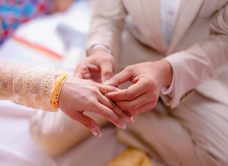 Man putting engagement ring on woman photo and close up of asian person