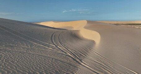Top-down view of vast white sand dunes with scattered lagoons at Lençóis Maranhenses National Park. - Powered by Adobe