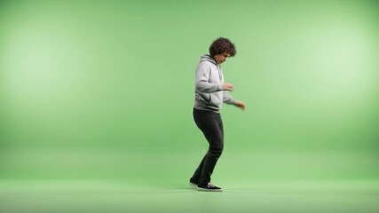Energetic Young Man Dancing Freely on Green Screen Background - Powered by Adobe