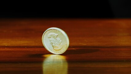 silver coin spinning on table in slow motion - Powered by Adobe