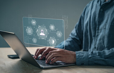 Cyber security focuses on data protection as a person uses a laptop to login, password protection...