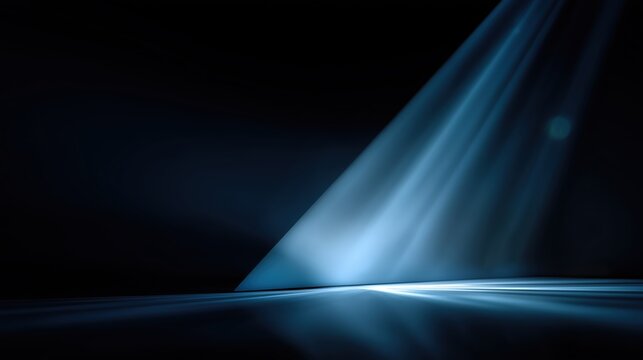 Beam of light cutting through darkness for a dramatic background or elegant modern design element.