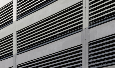 Ventilation facade closeup. Modern building with louver system, repetitive slats and geometric grid