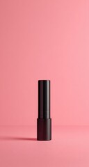 Obraz premium Black lipstick tube on pink backdrop