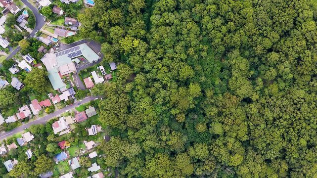 South Coast, NSW, Australia: Smooth Drone Flight from Thirroul Village over the forest, up the steep sandstone wall of Illawarra Range, to the Panorama House at Bulli Pass Lookout.