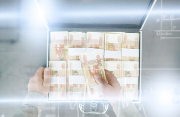 A metal suitcase filled with Russian banknotes of 5000 rubles. Double exposure. Investment, bribe,...