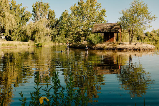 Teenagers fishing and playing in a peaceful lake