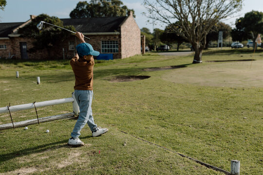 Young boy swinging a golf club