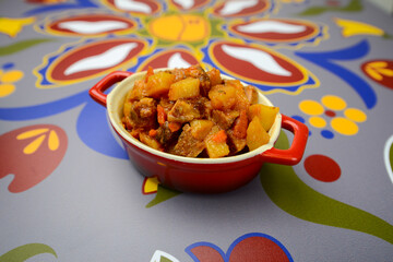 stewed potatoes in a red pan