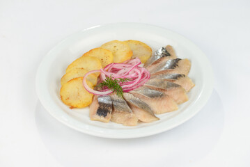 herring with potatoes on a white plate
