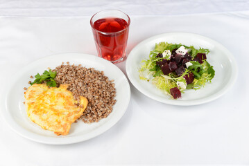 lunch buckwheat with chop and beet salad on a white background