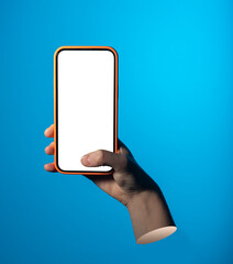 Phone screen mockup in hand against blue background. Thumb taps display to simulate mobile app use