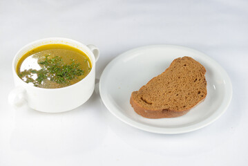 soup with bread on a white background