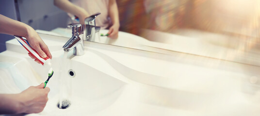 Tooth brush and paste with mirror background in the bathroom. Close up of toothpaste and...