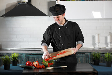 Man cook preparing food at the kitchen of vegetables