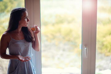 A girl at the window in the house