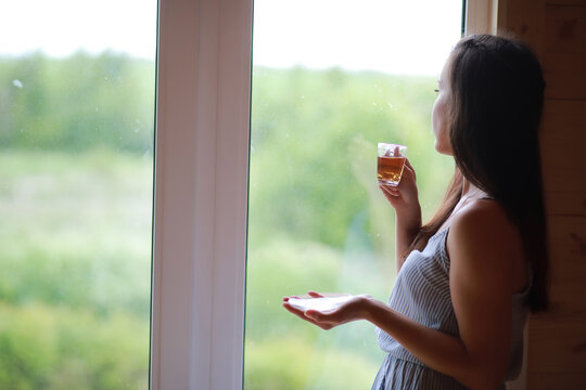 A girl at the window in the house