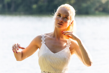 Blonde Woman in White Dress by the Lake