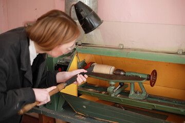 Young woman engineer working at machine tool