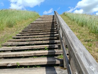 Salduve hill during sunny day. Small hill. Grass is growing on hill. Staircase leading to the top....