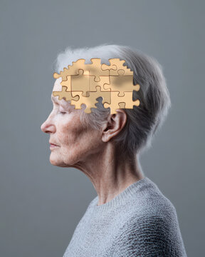 Elderly woman with closed eyes and white hair in side profile with puzzle pieces overlay on head symbolizing memory loss and cognitive decline