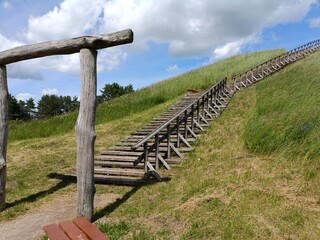 Salduve hill during sunny day. Small hill. Grass is growing on hill. Staircase leading to the top....