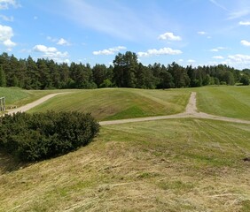 Salduve hill during sunny day. Small hill. Grass is growing on hill. Staircase leading to the top....