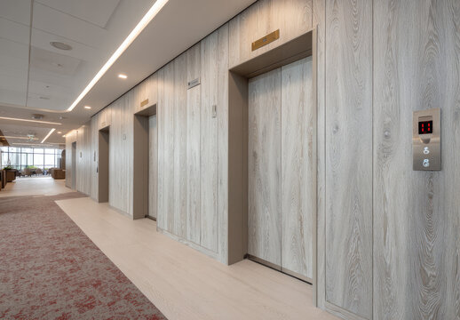 Modern elevator lobby with light wood paneling
