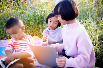 Kids exploring in forest with a magnifying glass