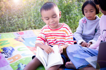 Kids exploring in forest with a magnifying glass