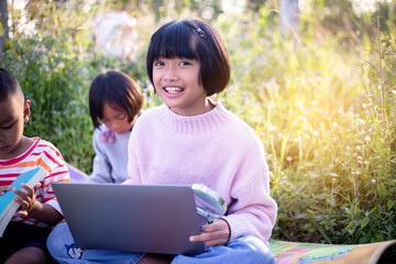 Kids exploring in forest with a magnifying glass