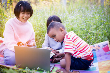 Kids exploring in forest with a magnifying glass