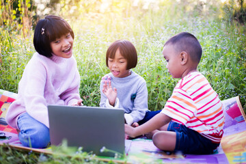 Kids exploring in forest with a magnifying glass